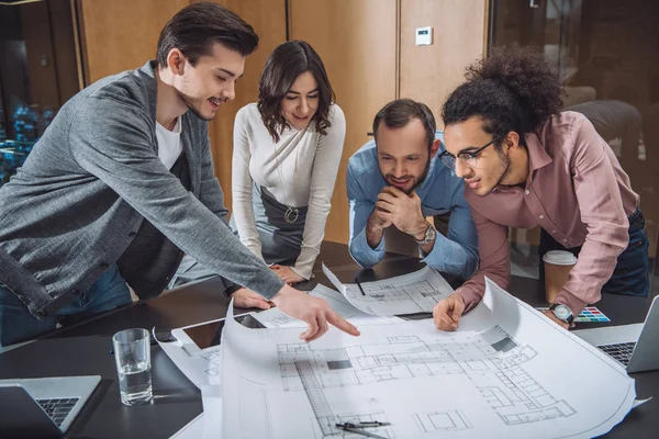 Group of professional architects discussing building plans at office — Stock Photo