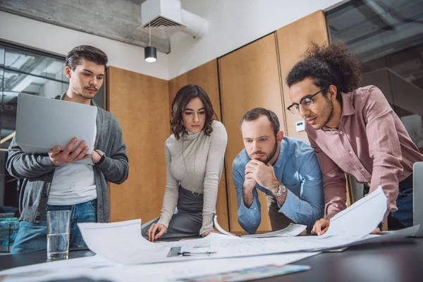 Group of thoughtful architects working together at office — Stock Photo