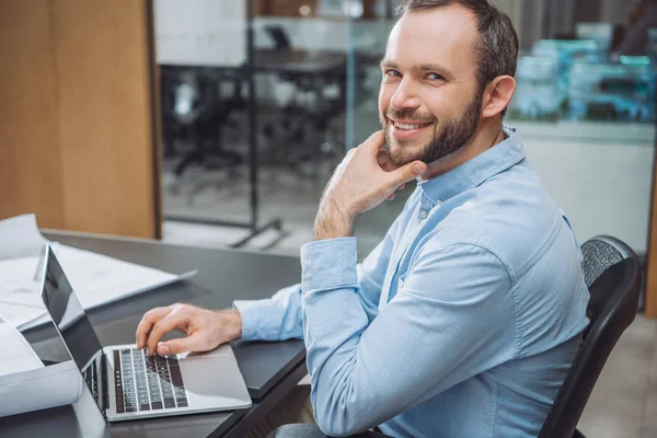 Happy successful architect working with laptop at office — Stock Photo