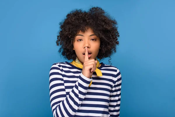African american young girl showing silence symbol, isolated on blue — Stock Photo