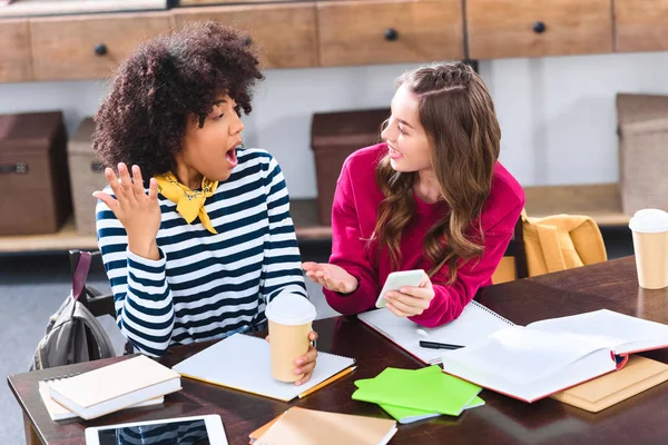 Portrait of multicultural students with smartphone studying together — Stock Photo