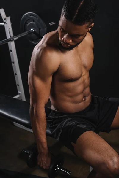 High angle view of muscular shirtless african american man training with dumbbell — Stock Photo