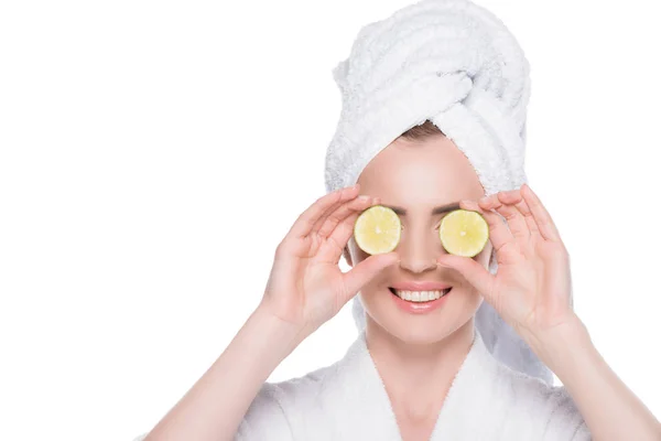 Woman with clean skin closing eyes by slices of lime isolated on white — Stock Photo