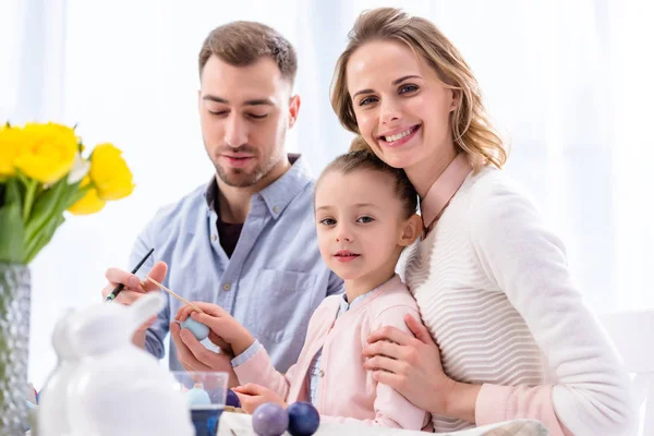 Parents and daughter celebrating with Easter eggs — Stock Photo