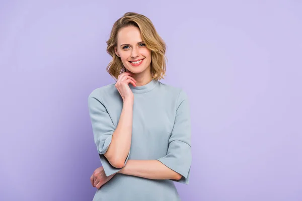 Young blonde woman with hand near face isolated on violet — Stock Photo