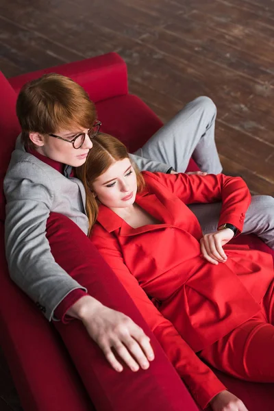 High angle view of stylish male in eyeglasses with lying girlfriend — Stock Photo