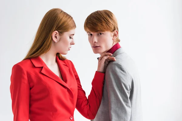 Female fashion model holding hand on boyfriend shoulder isolated on grey — Stock Photo