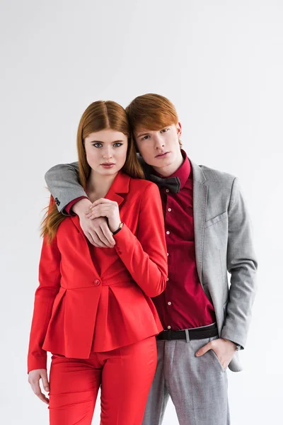 Portrait of young couple of fashion models isolated on grey — Stock Photo
