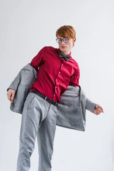 Low angle view of male fashion model in eyeglasses isolated on grey — Stock Photo