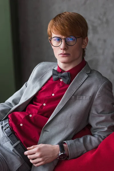 Portrait of male fashion model dresed in suit and bow tie — Stock Photo