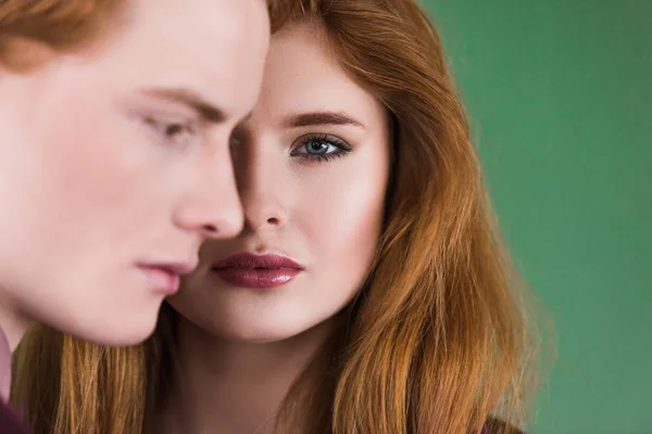 Side view of male fashion model and half face of young female — Stock Photo