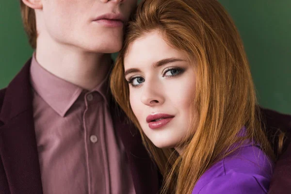 Cropped view of young male model face with girlfriend isolated on green — Stock Photo