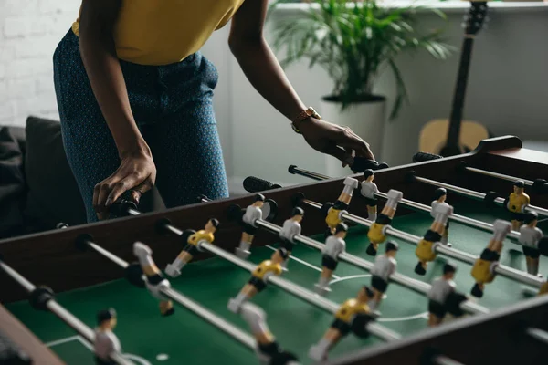 Cropped shot of young african american woman playing foosball — Stock Photo