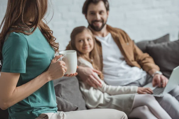 Cropped image of mother holding cup of coffee — Stock Photo