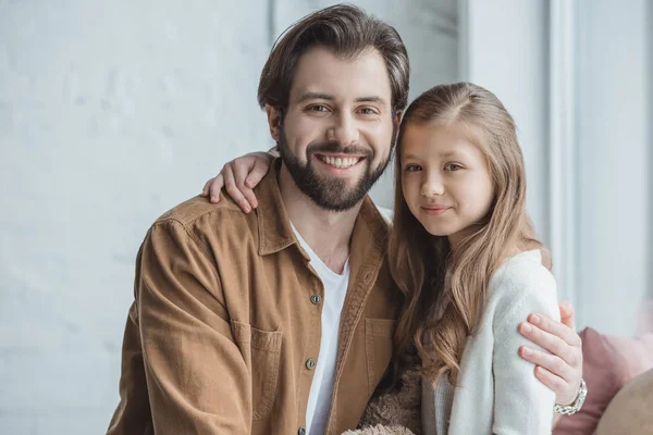 Happy father and daughter looking at camera at home — Stock Photo