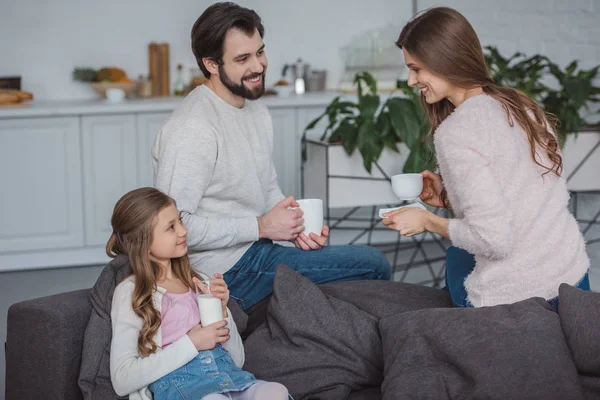 Parents and daughter drinking milk and coffee in morning — Stock Photo