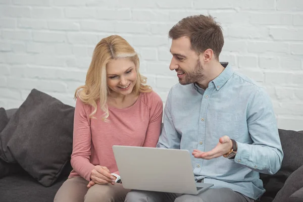 Portrait of grown son and mother using laptop together at home — Stock Photo