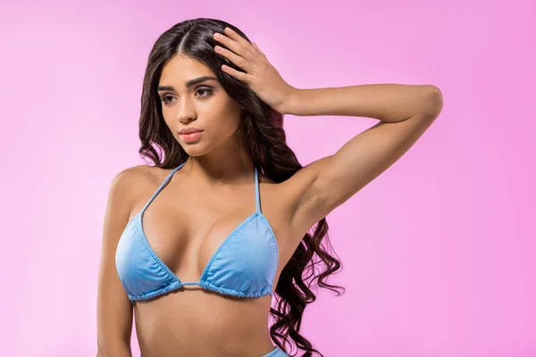 Beautiful tanned girl posing in trendy blue bikini, isolated on pink — Stock Photo