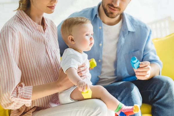 Cropped view of young parents playing with infant daughter — Stock Photo