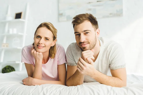 Portrait of young caucasian couple in bed — Stock Photo