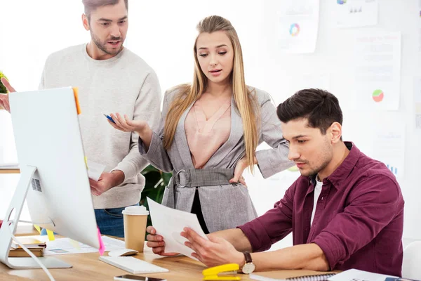 Young business people discussing new marketing strategy at workplace in office — Stock Photo