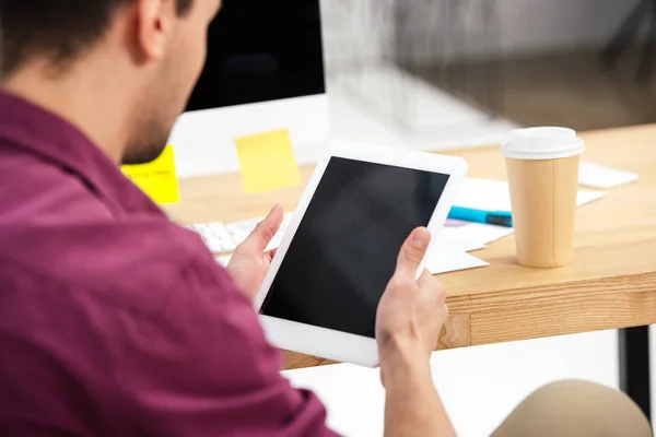 Partial view of businessman using tablet with blank screen at workplace in office — Stock Photo