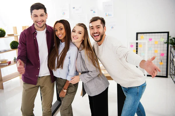 Portrait of happy multiracial business people looking at camera in office — Stock Photo