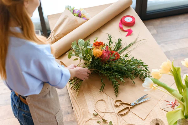 Cropped shot of young florist working with flowers at workplace — Stock Photo