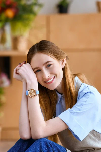 Portrait of beautiful young female florist smiling at camera — Stock Photo