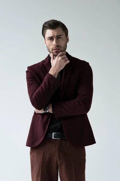 Handsome thoughtful man posing in trendy suit, isolated on grey — Stock Photo