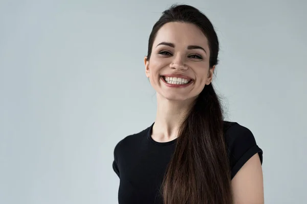 Portrait of young smiling woman, isolated on grey — Stock Photo