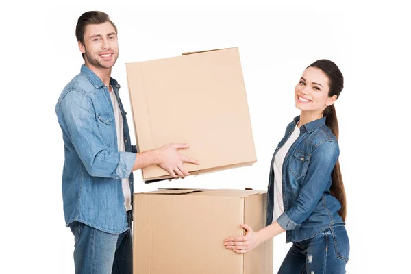 Smiling couple carrying cardboard boxes, isolated on white — Stock Photo