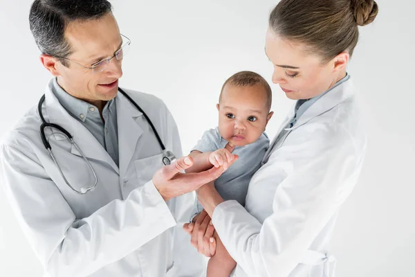Pediatricians taking care of little african american bab — Stock Photo
