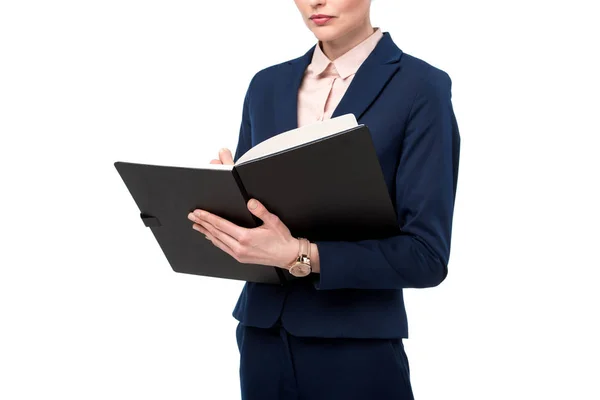 Cropped shot of businesswoman writing in notebook isolated on white — Stock Photo