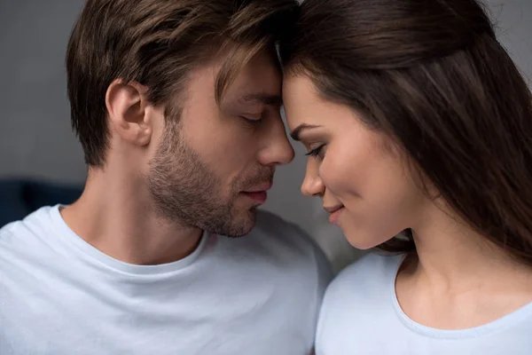 Romantic couple tenderly hugging in their room — Stock Photo