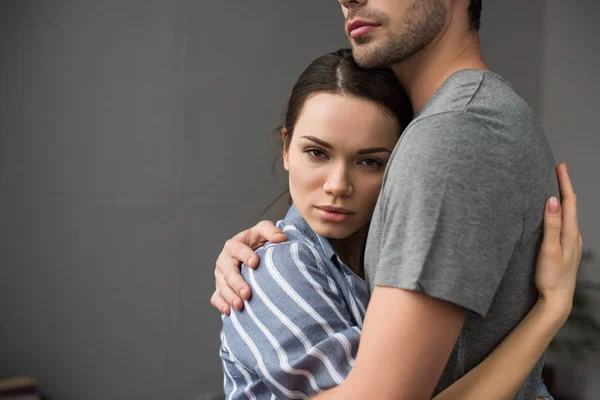 Brunette woman hugging her husband in bedroom — Stock Photo