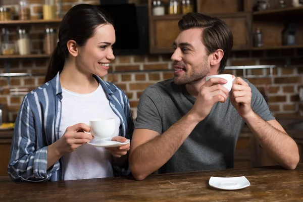 Smiling man and woman drinking coffee in the morning — Stock Photo