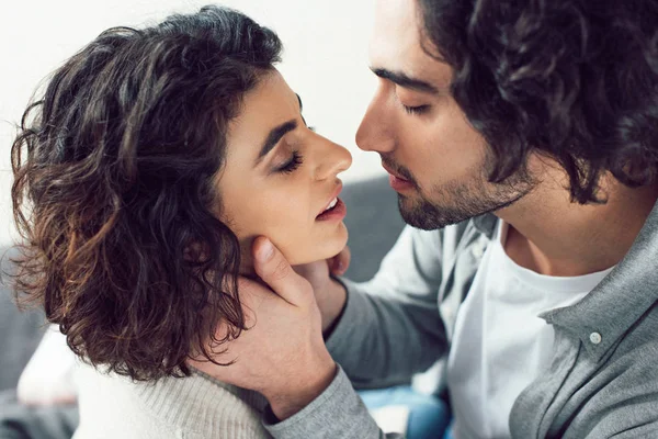 Affectionate couple going to kiss at home — Stock Photo