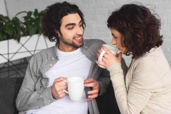 Young couple drinking coffee in morning at home — Stock Photo