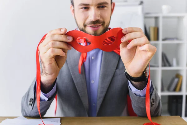 Super homem de negócios olhando para máscara vermelha no escritório — Fotografia de Stock