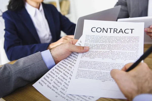 Cropped image of businessman signing contract in office — Stock Photo