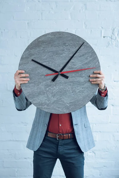 Man holding large clock in front of his face — Stock Photo