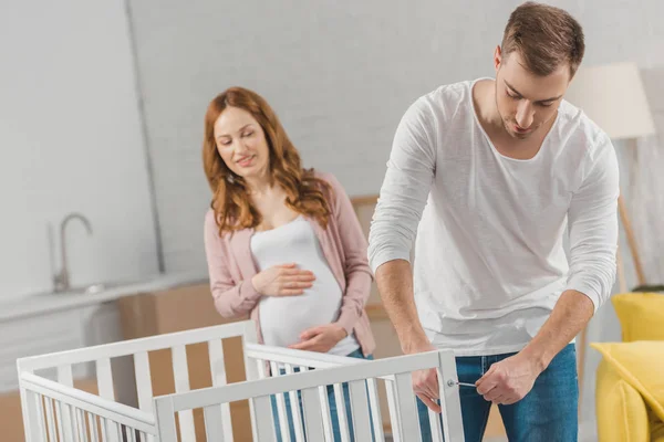 Assembling a baby bed — Stock Photo