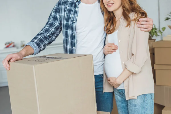Tiro cortado de mulher grávida e marido no novo apartamento, conceito de realocação — Fotografia de Stock