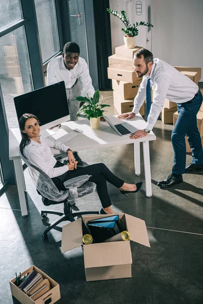 Vue en grand angle de collègues multiethniques heureux travaillant ensemble dans un nouveau bureau — Photo de stock