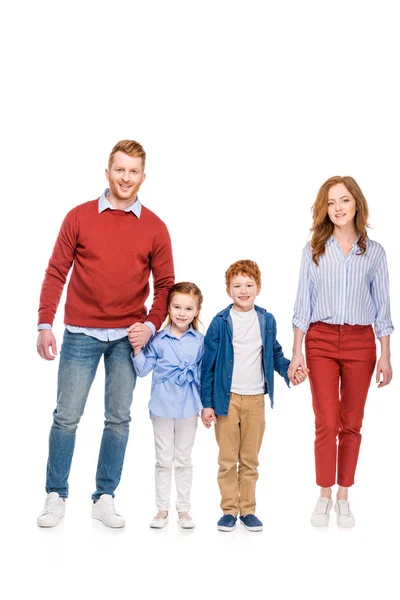 Heureux rousse famille avec deux enfants tenant la main et souriant à la caméra isolé sur blanc — Photo de stock