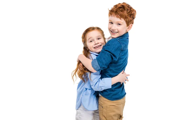 Beautiful redhead brother and sister hugging and smiling at camera isolated on white — Stock Photo