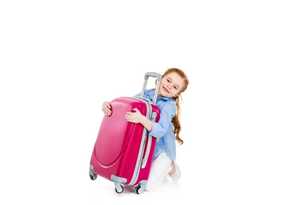 Adorable happy child hugging pink suitcase isolated on white — Stock Photo