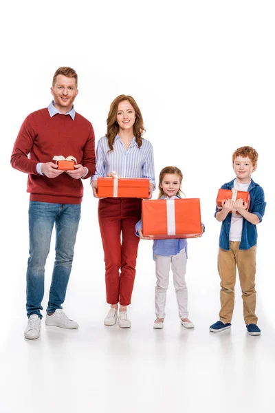 Glücklich rothaarige Familie hält Geschenkboxen und lächelt in die Kamera isoliert auf weiß — Stockfoto