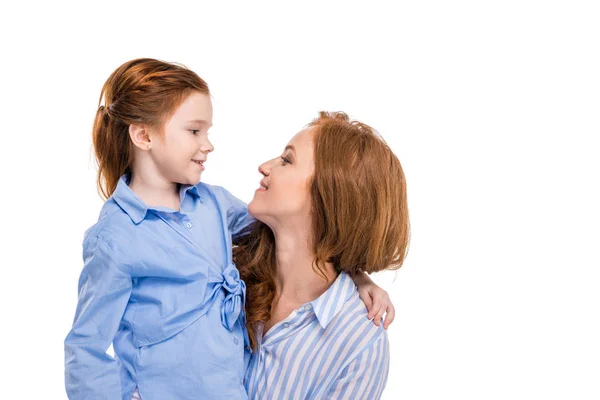 Beautiful redhead mother and daughter smiling each other isolated on white — Stock Photo